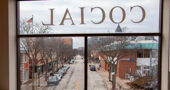 Photo of downtown Arlington Heights through the window of the Cocial building